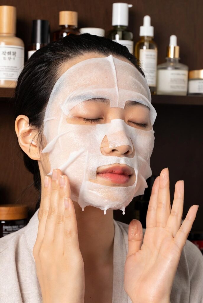 A glowing woman with dewy glass-like Korean skin surrounded by elegant skincare products including toners, serums, and botanicals, representing 20 Korean skin care ideas for a naturally radiant complexion.