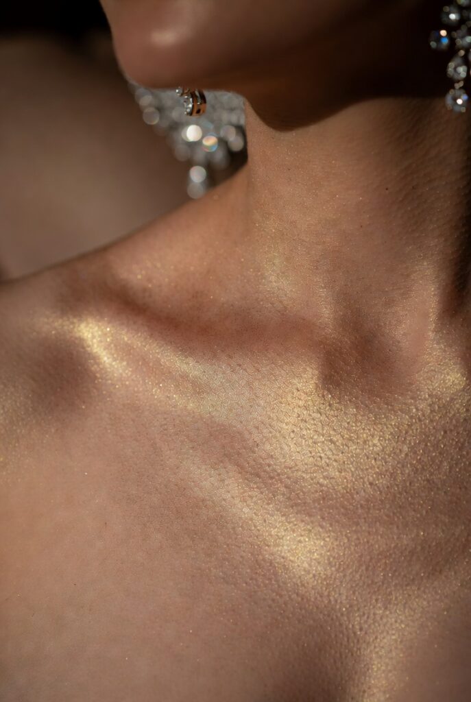 21. Gold Speckled Body Oil on Collarbones